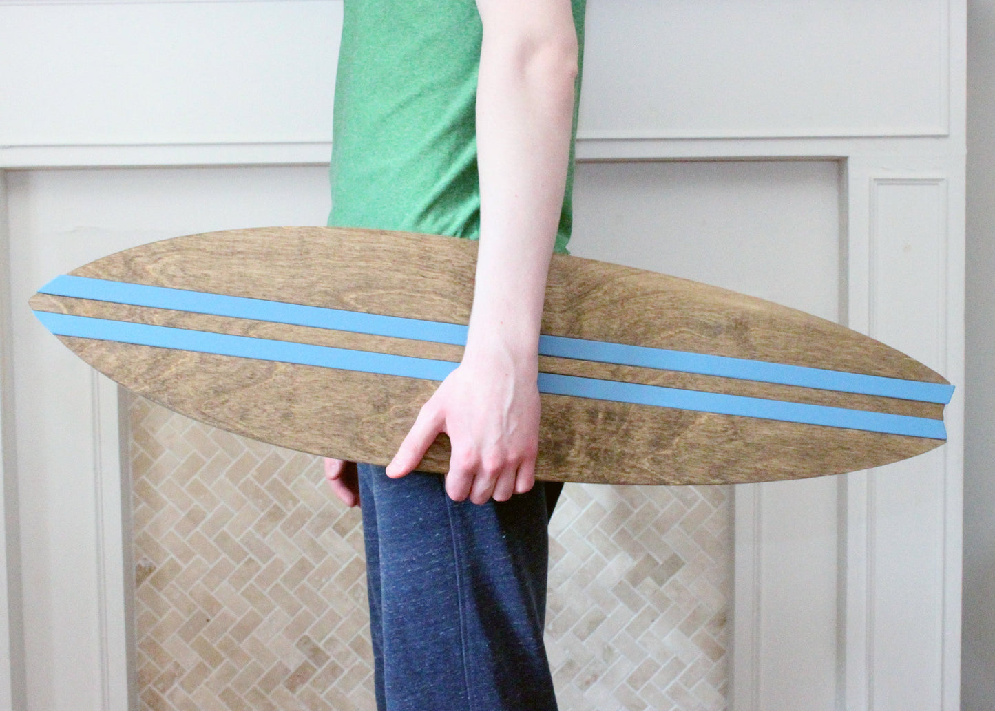 Wooden surfboard wall decor with custom colored accent inlays for beach inspired room